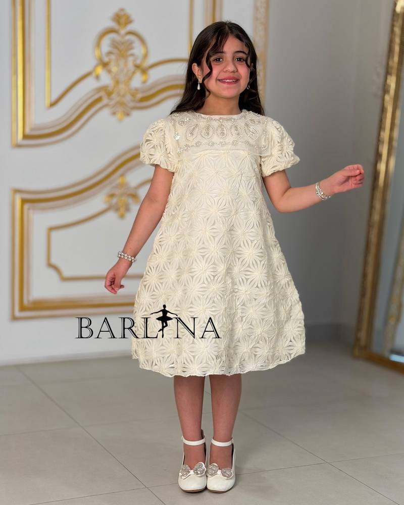 Off-white girls' dress with patterned fabric