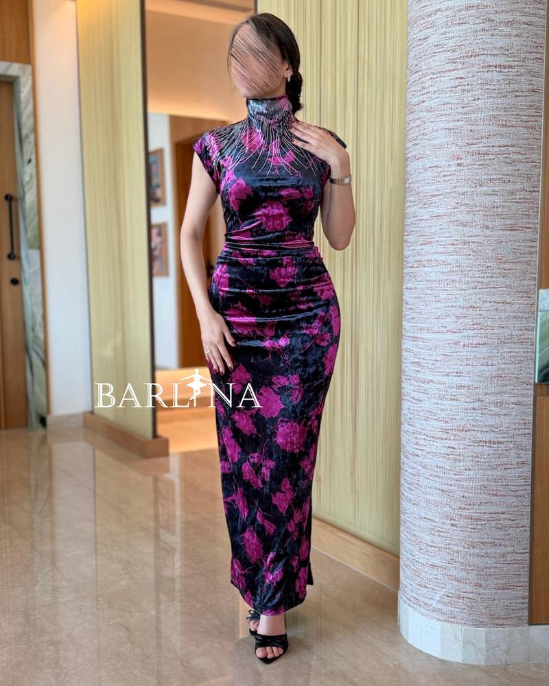 A fitted black velvet dress with floral accents