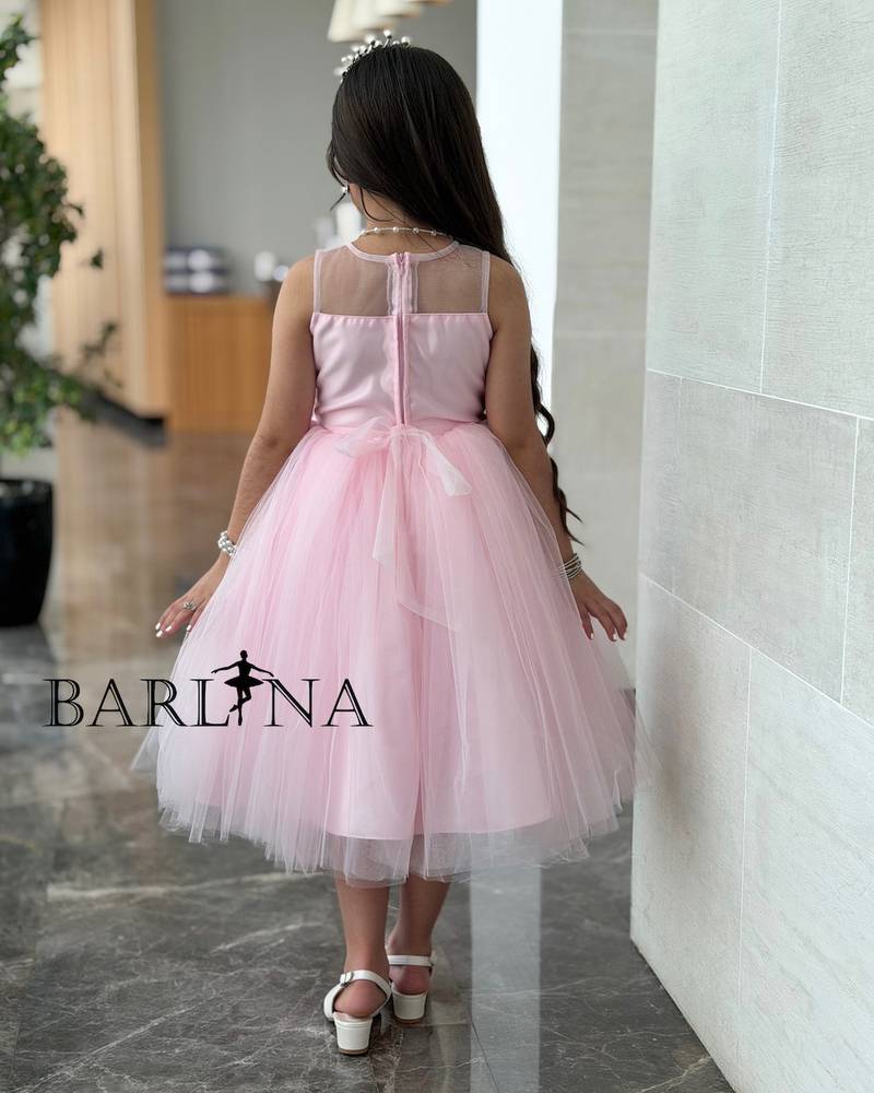Pink girl's dress decorated with flowers and sparkly embroidery