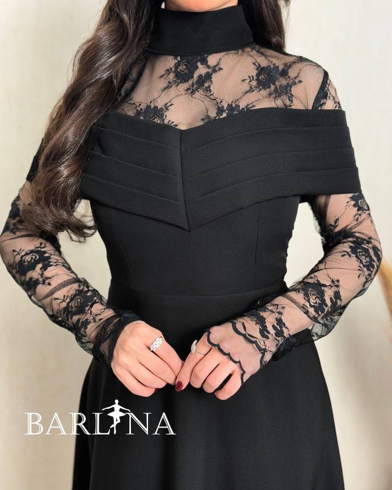 A soft black dress with sheer lace sleeves