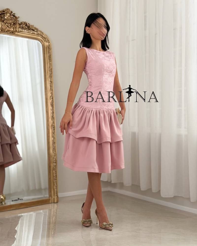 A soft dress with a low waist and layers of ruffles