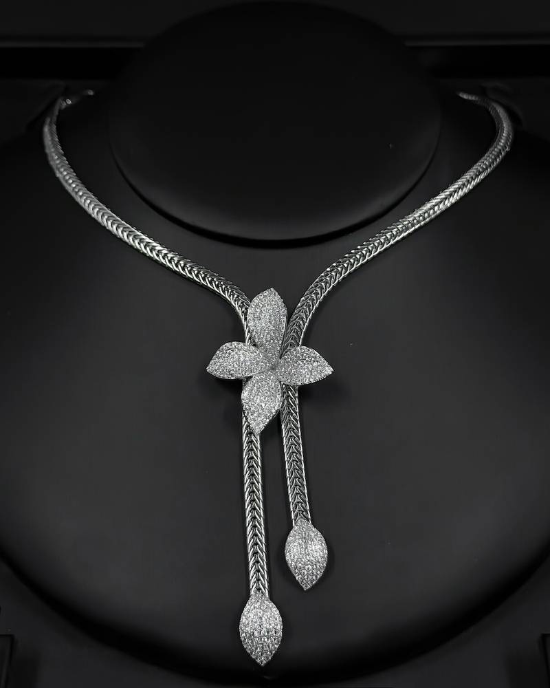 Silver accessory set with a four-petaled flower design