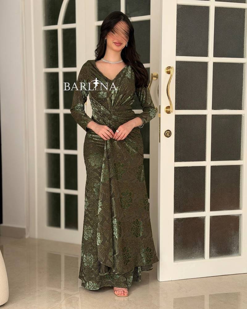 An olive-green evening dress embroidered with elegant designs.