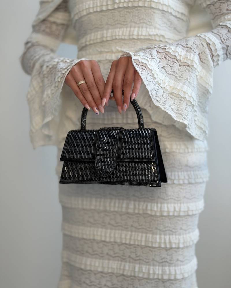 An evening bag completely covered in crystal studs