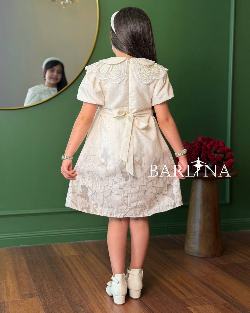 A short girl's dress decorated with delicate embroidery