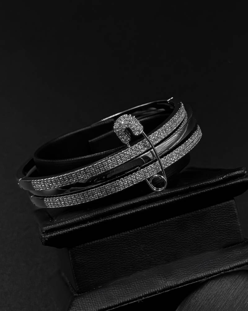 Bracelet and ring designed with crossed studded lines