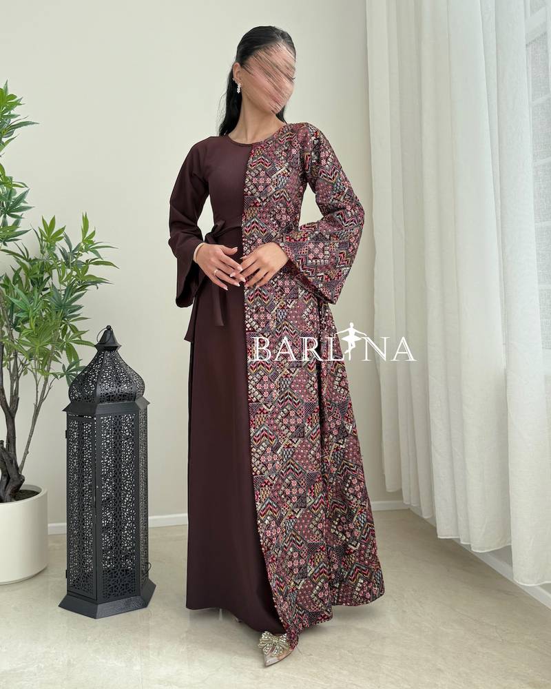 A maroon djellaba with a colorful traditional pattern