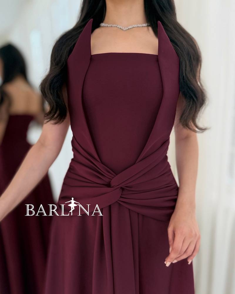 A flowing burgundy dress with a draped knot