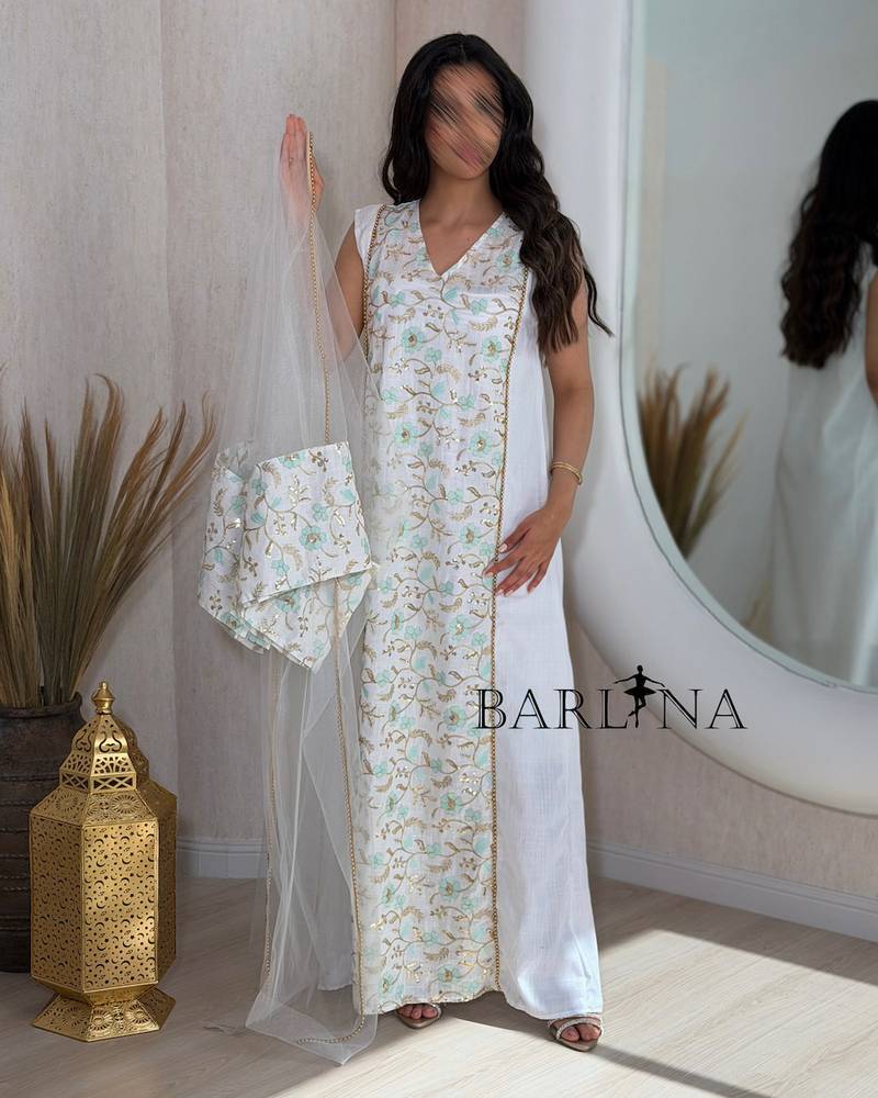 White jalabiya with gold embroidery and turquoise accents