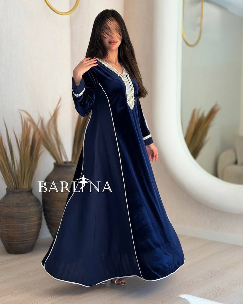 A navy blue flared jalabiya decorated with crystals