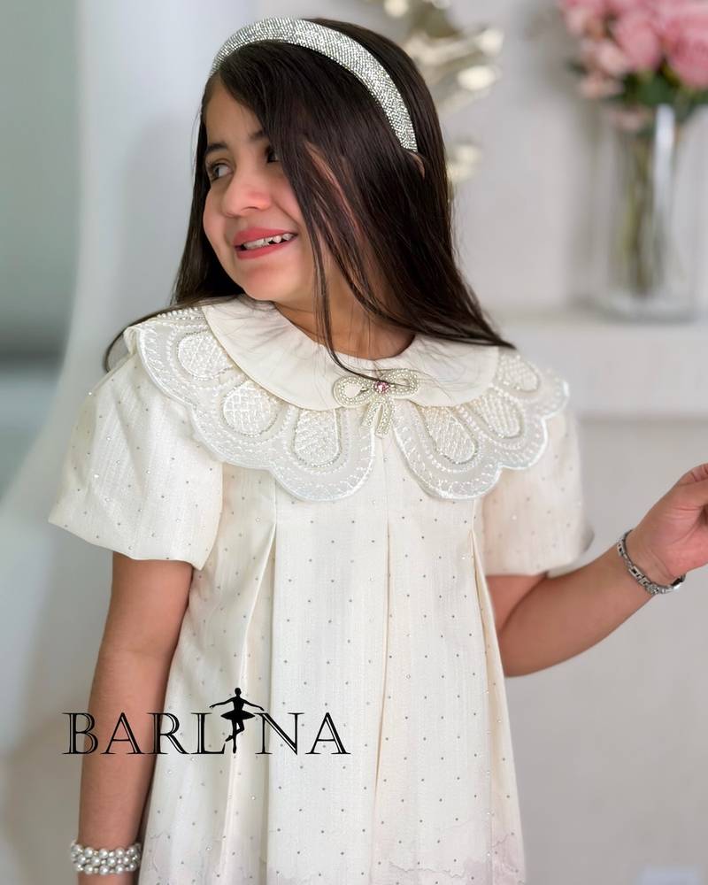 A short girl's dress decorated with delicate embroidery