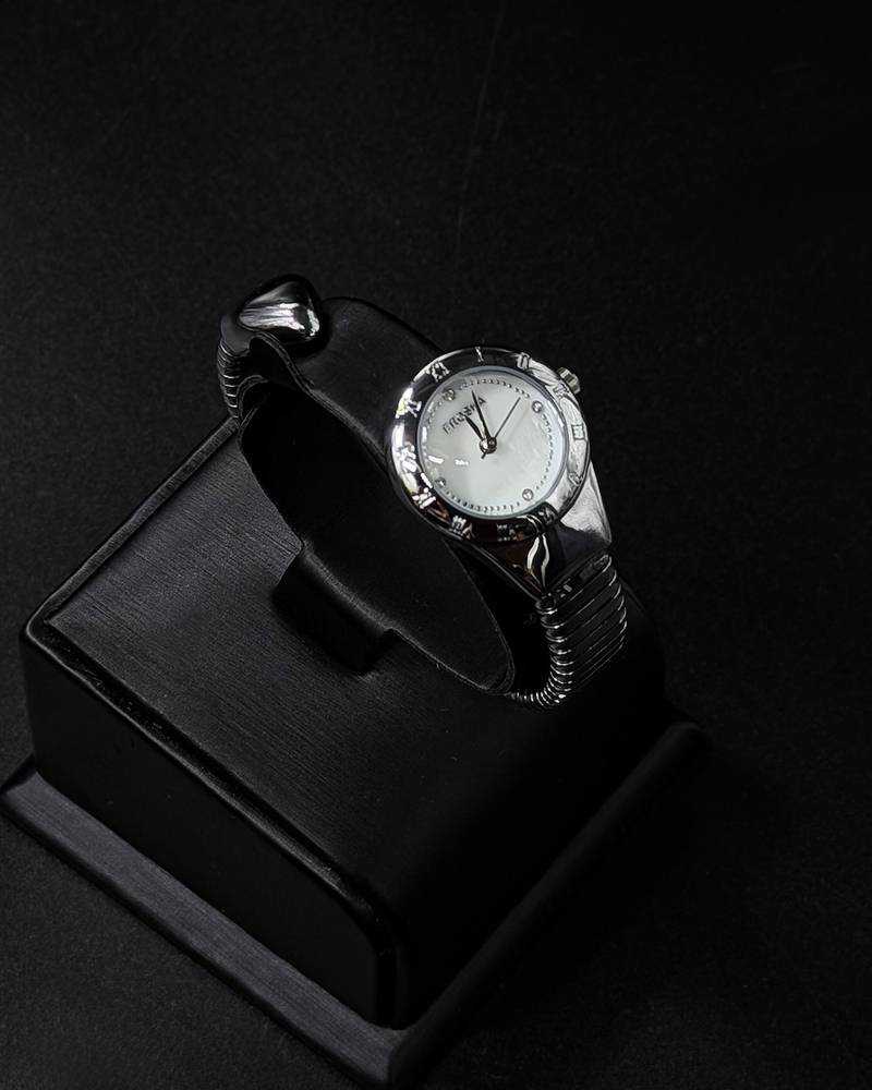 A women's watch with a delicate design and an open strap.