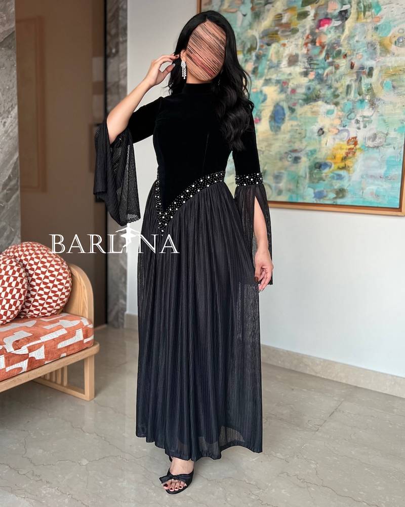 Black dress with open sleeves decorated with pearls