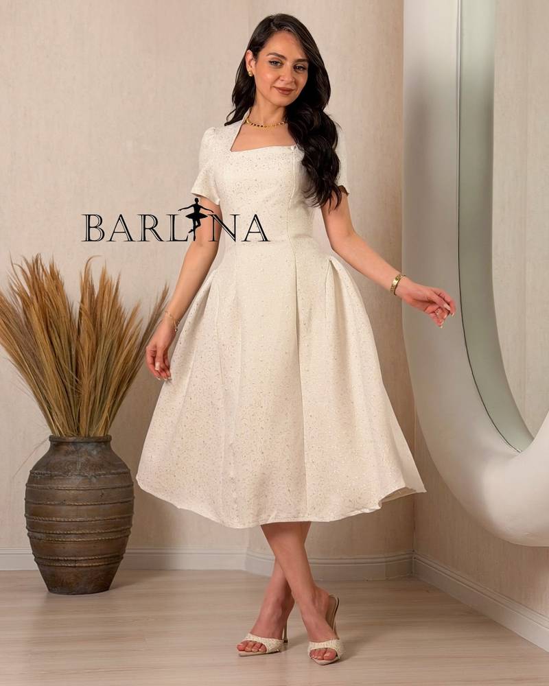 A classic off-white dress with delicate patterns