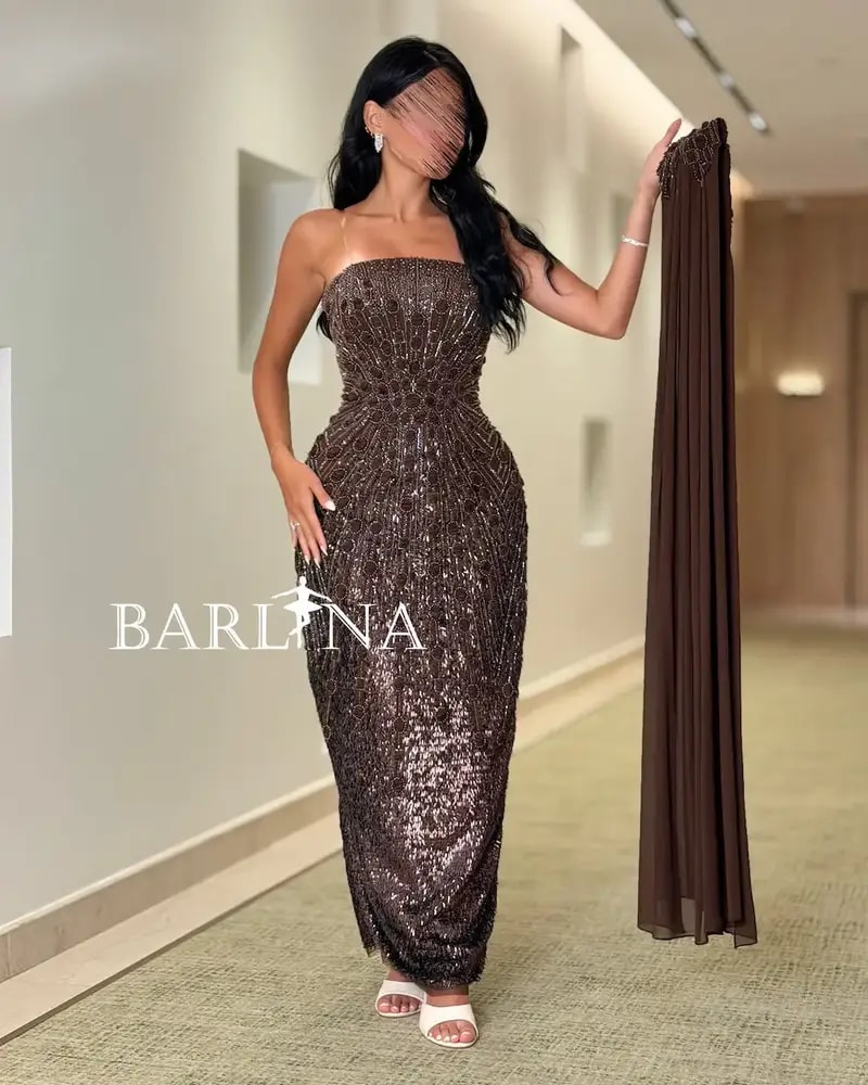 A shimmering brown dress with luxurious details and a shawl