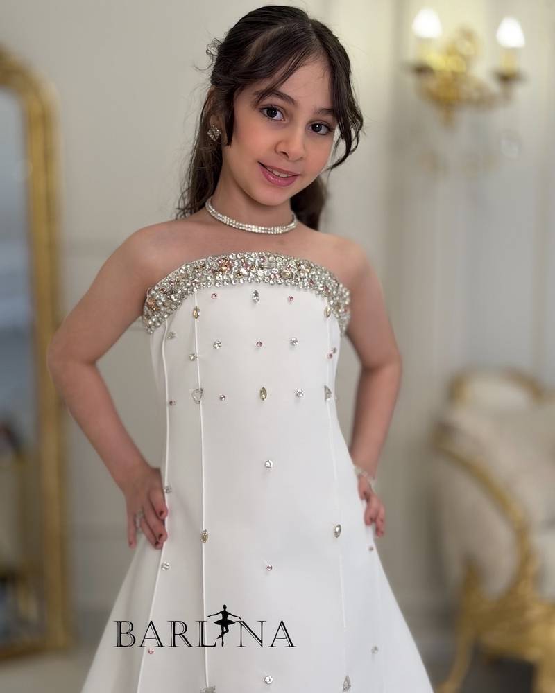 White girl's dress decorated with crystal details