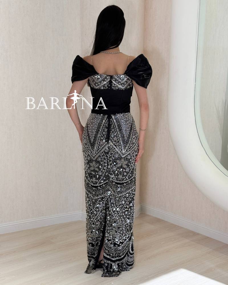 Black evening dress with heavy silver embroidery