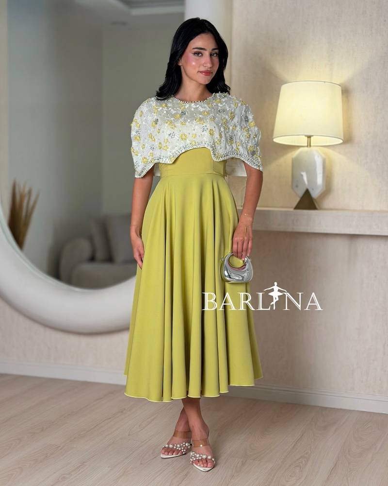 Elegant apple-colored dress with embroidered top