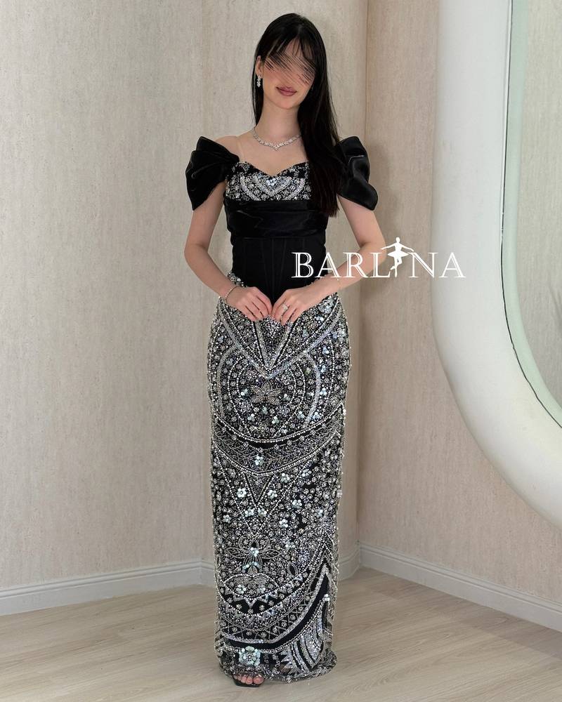 Black evening dress with heavy silver embroidery