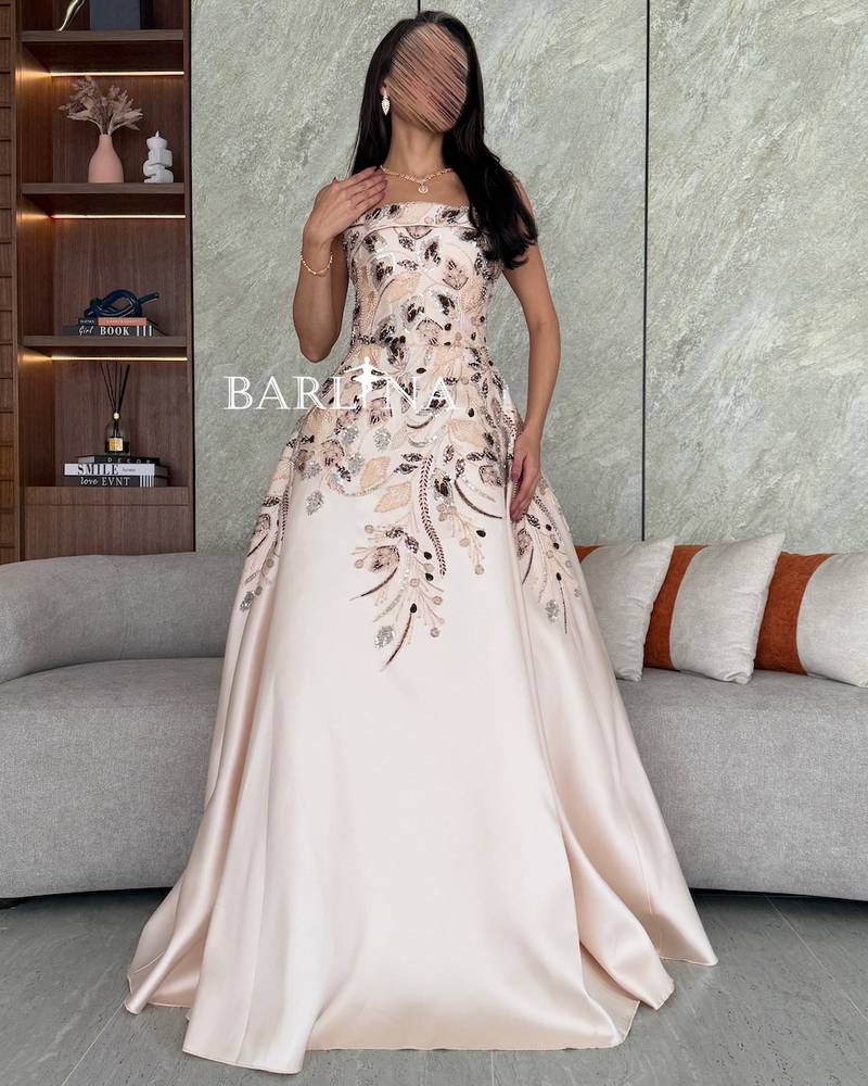 Cream evening dress embroidered with floral motifs