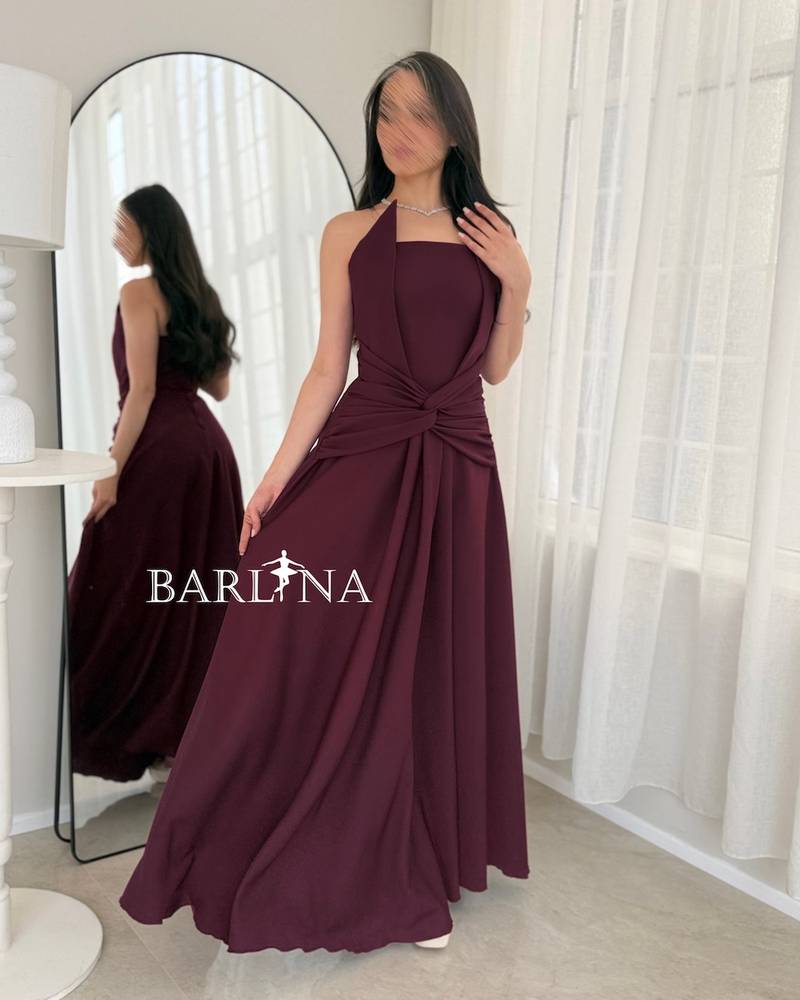 A flowing burgundy dress with a draped knot
