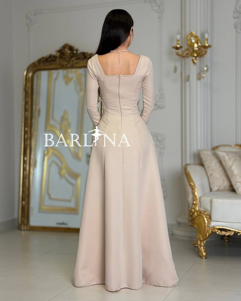 Long beige dress adorned with luxurious embroidery
