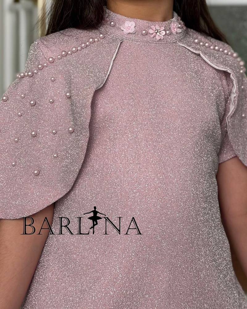 A shiny dress with a straight cut and a ruffled hem.