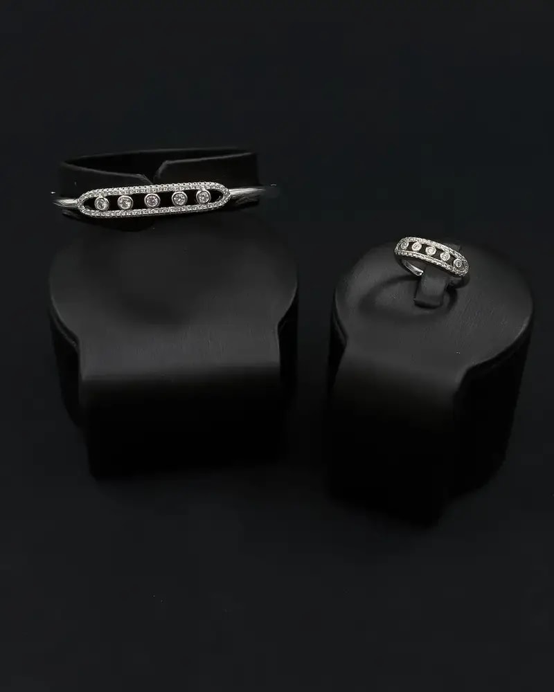Bracelet and ring with an oval design studded with gemstones