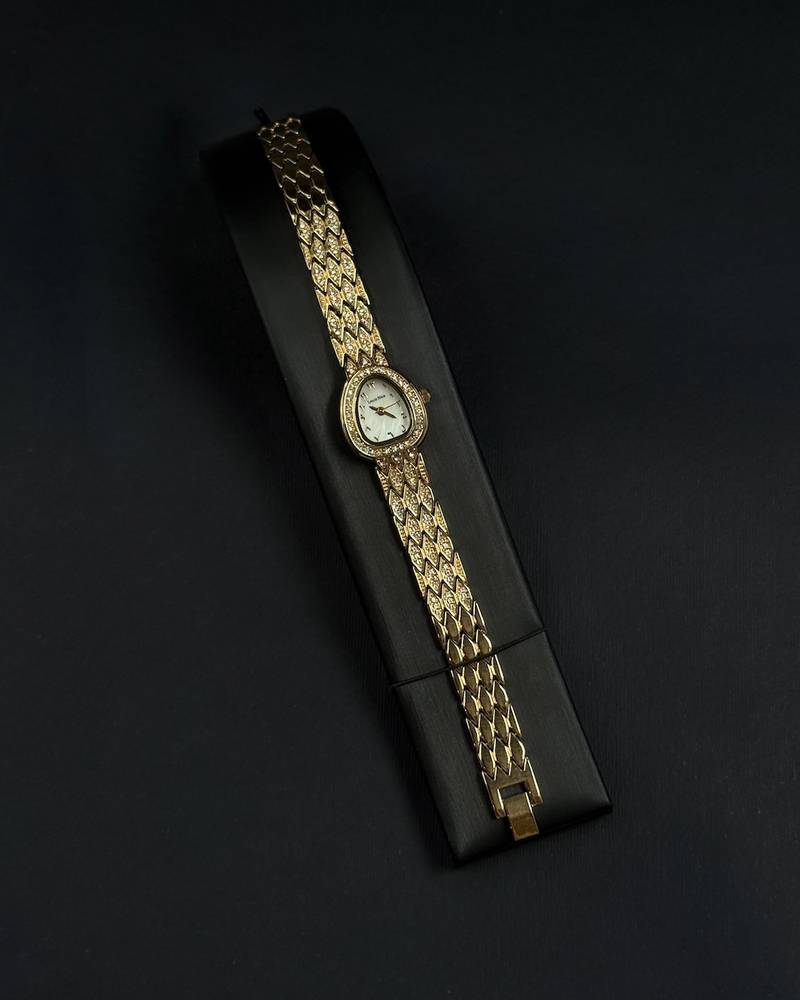 A luxury watch with a geometrically designed studded bracelet.
