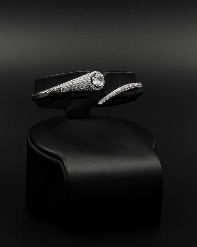 Bracelet and ring with fine details and a shiny stone in the middle