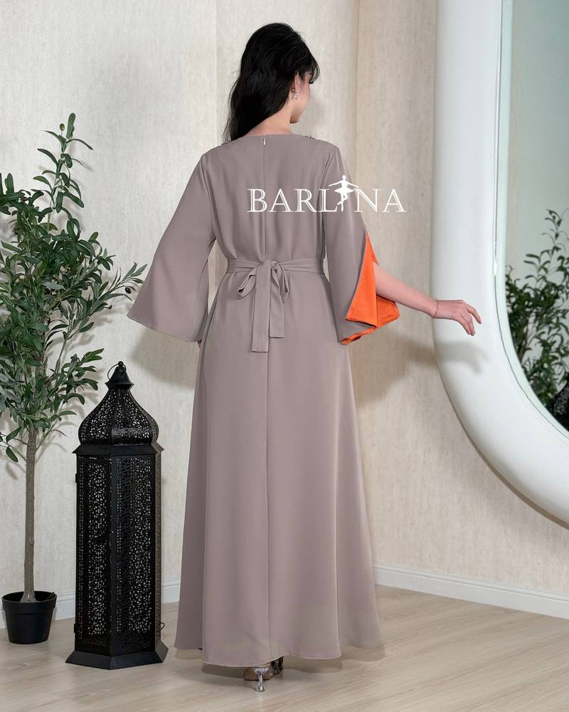 A soft gray jalabiya adorned with delicate embroidery