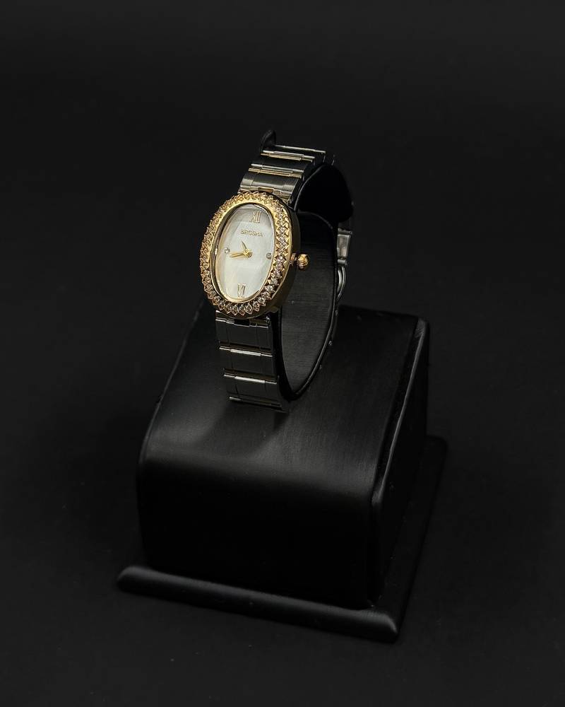 An oval-shaped watch surrounded by crystal