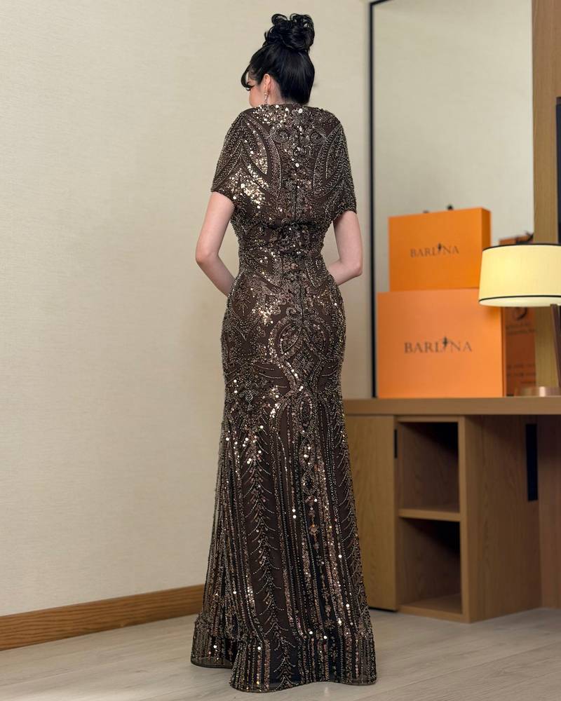 A brown evening dress fully embroidered with sequins