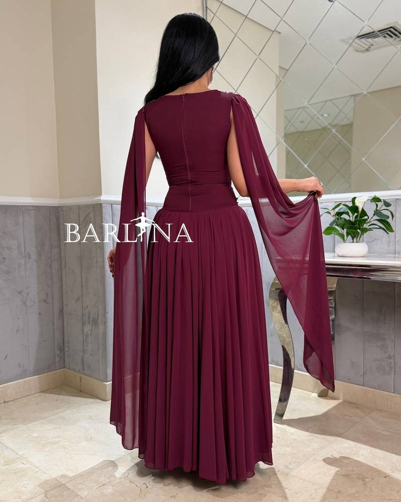 A flowy berry-colored dress with a royal long cape