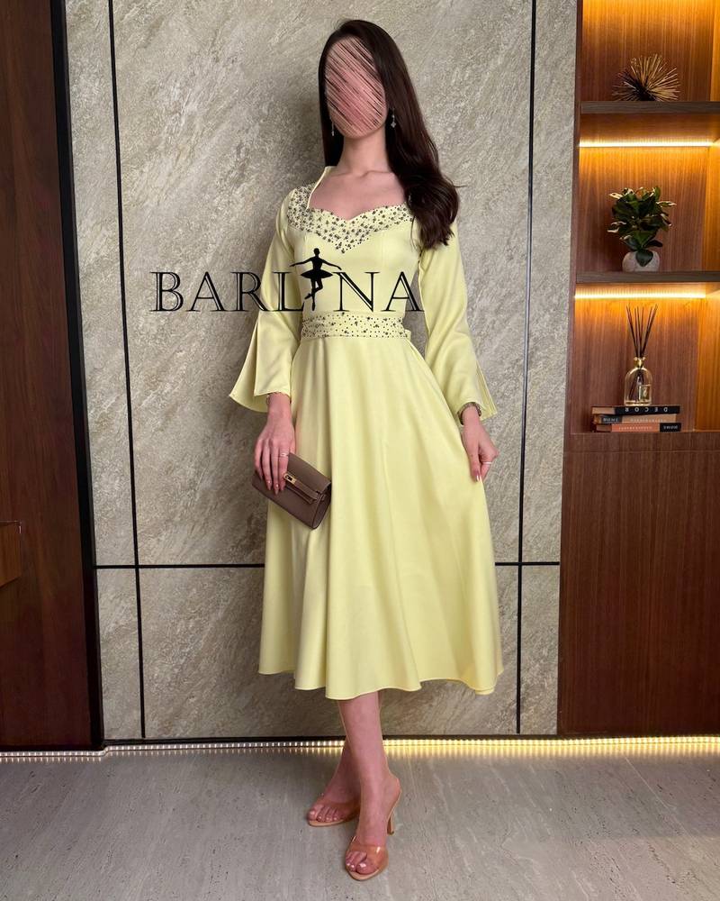 Yellow midi dress with pearls around the neck