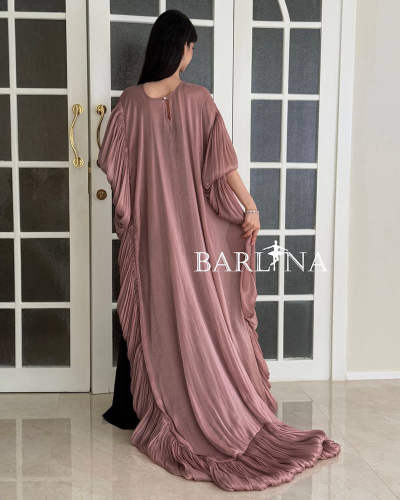 Black dress with a long pink pleated shawl cape