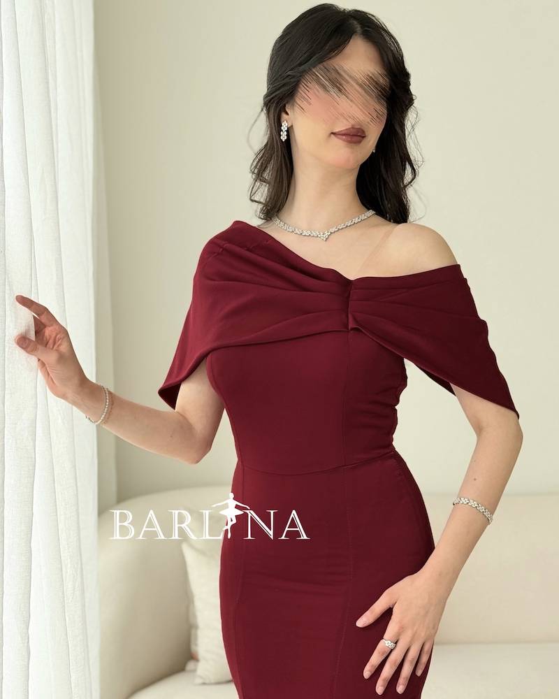 A soft burgundy dress with wide draped shoulders