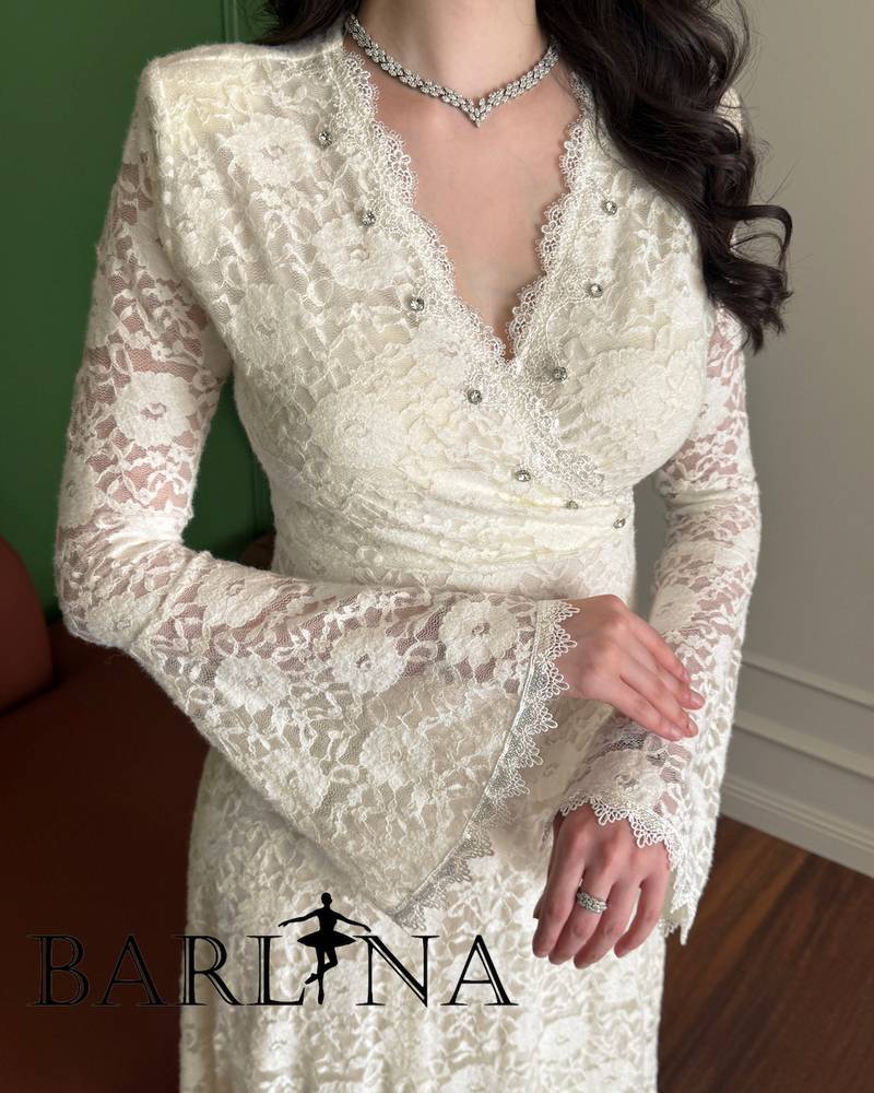 An elegant off-white dress with long sleeves