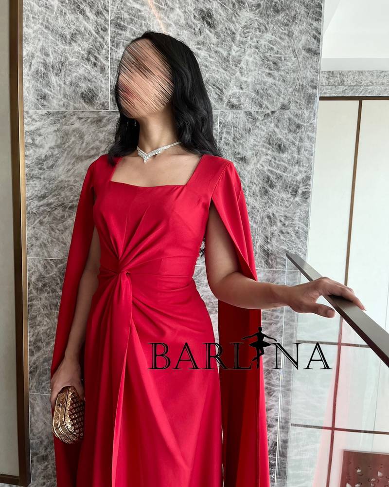 Long red dress with twisted design and cape sleeves
