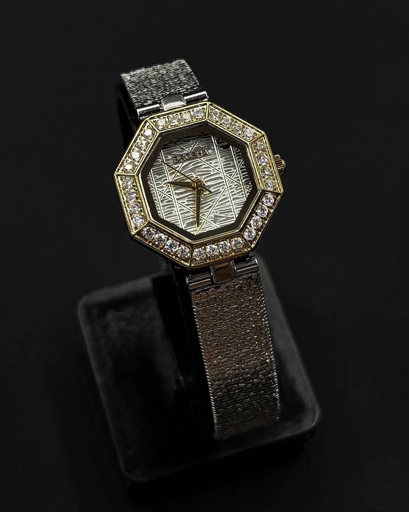 An octagonal bezel wristwatch studded with gemstones
