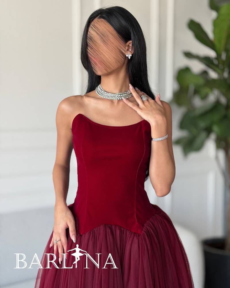A burgundy puffy dress with a simple corset
