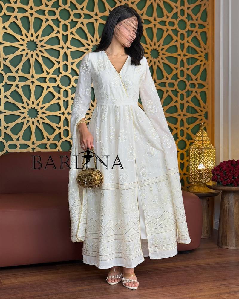 White jalabiya with delicate embroidery and gold accents