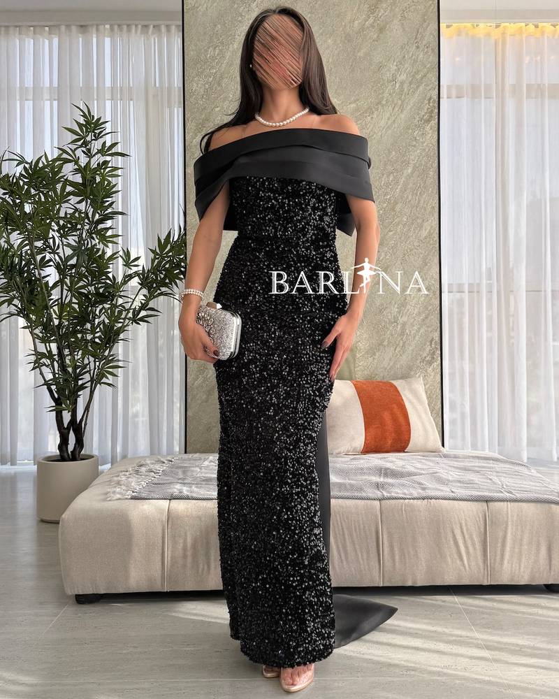 Black shiny dress with a long and distinctive design