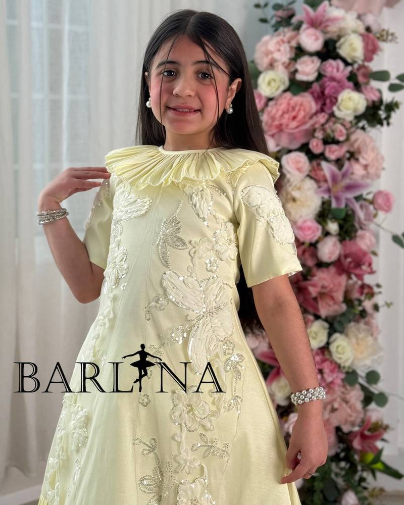 Yellow girls' dress with ruffles and delicate embroidery