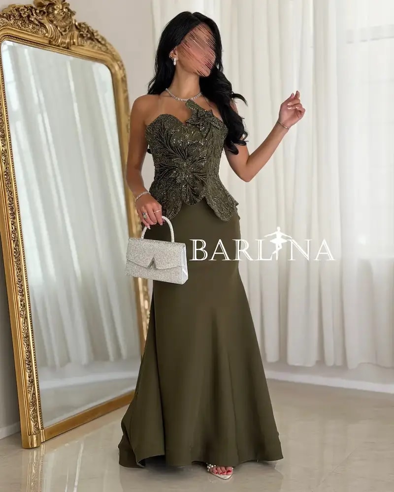 Olive green dress with prominent embroidery details