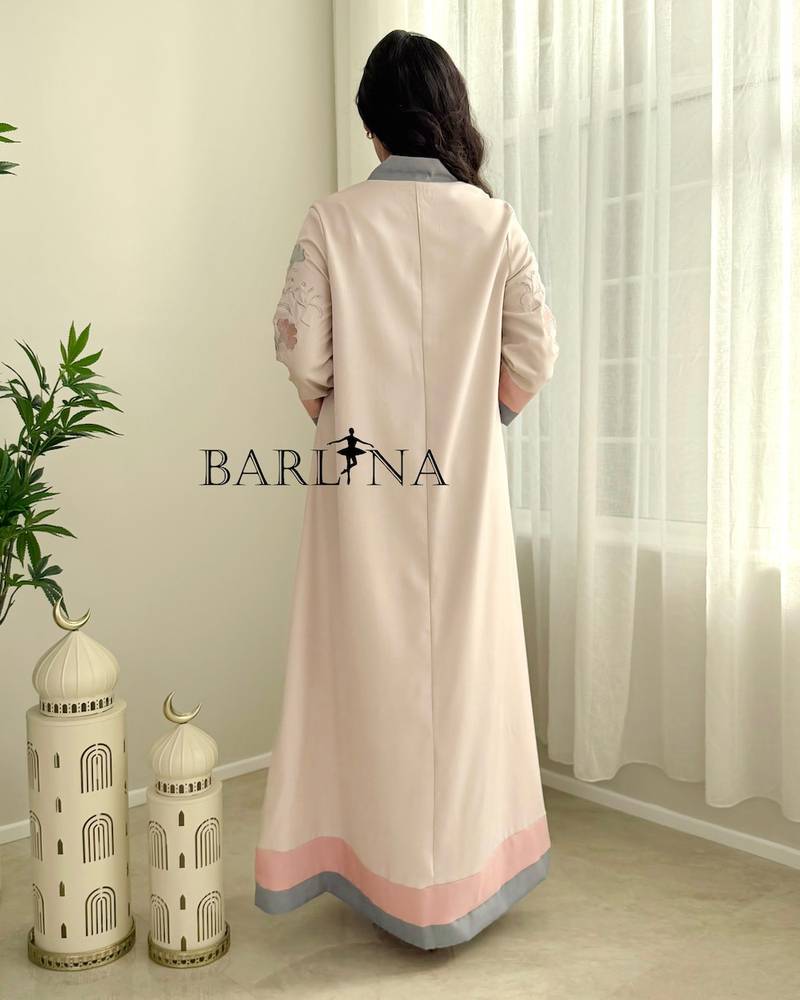 Cream-colored jalabiya with delicate embroidery and colored edges