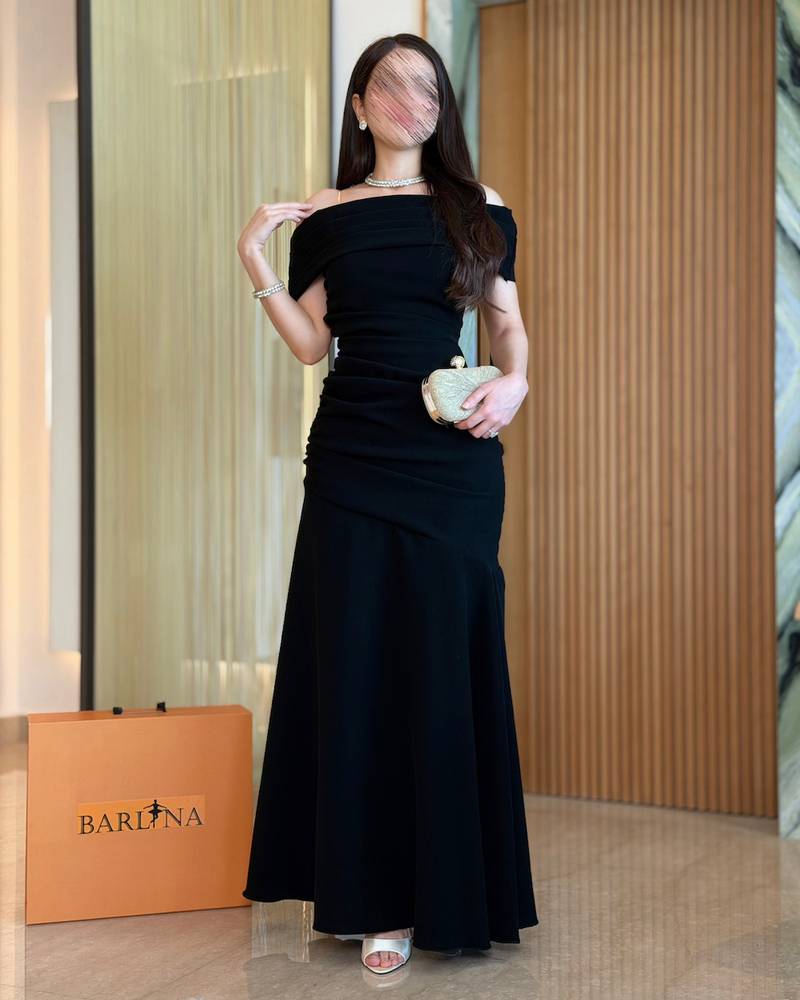 Black off-shoulder dress with an elegant draped cut