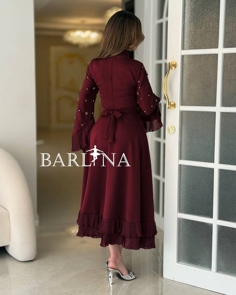 Burgundy dress with wide sleeves adorned with crystals