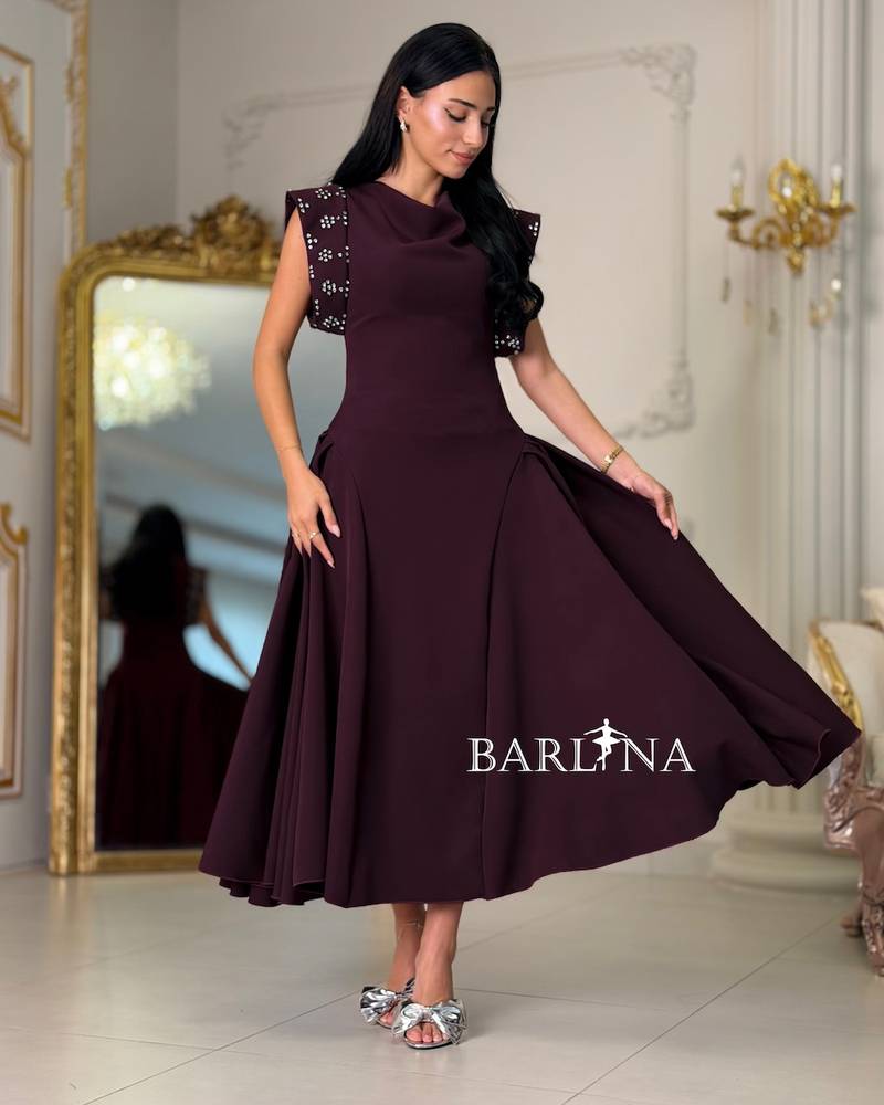 Maroon dress with embroidered shoulders and a flared silhouette