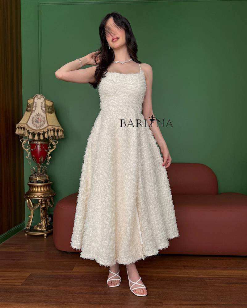 Soft off-white dress with a midi length and elegant details